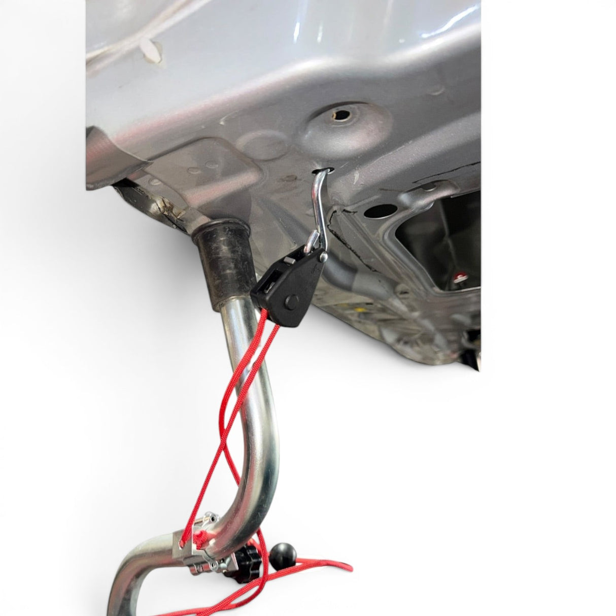 Anson PDR clamp-style rope ratchet with red cord attached to a car hood stand for dent repair.