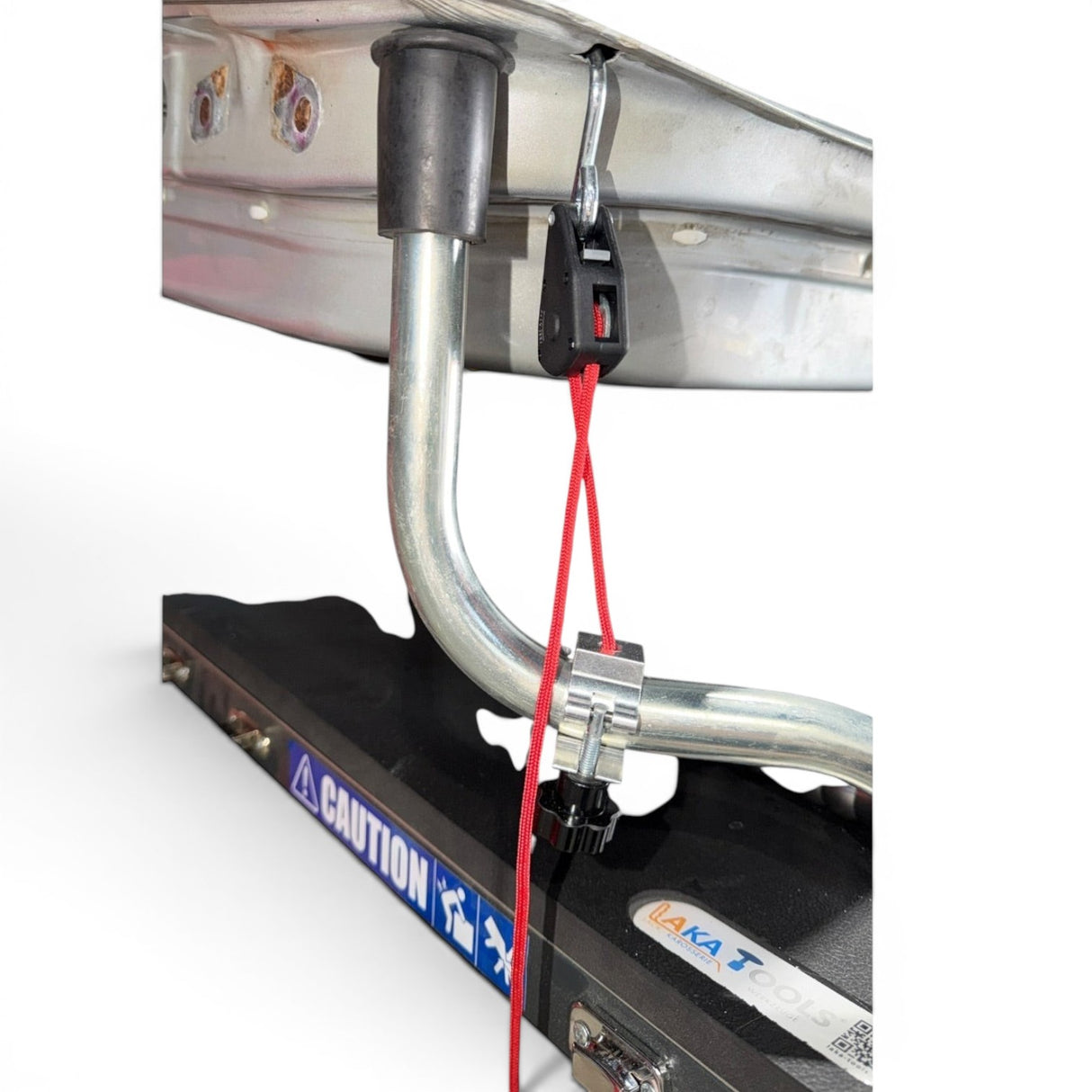 Anson PDR clamp style rope ratchet with red cord attached to a metal hood stand arm.