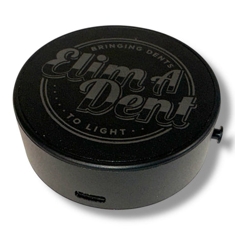 Anson PDR black circular auto cup base with Elimadent logo, USB-C charging port, and magnetic attachment.