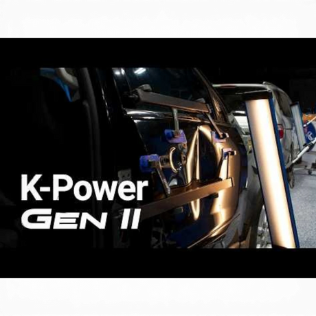 Keco K-Power Mini Gen 2 lateral tension tool on a black car door, used for hail damage repair.